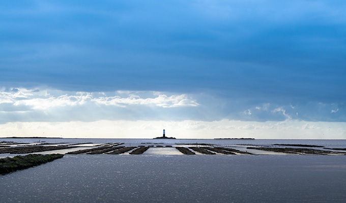 Photo of a lighthouse on the horizon